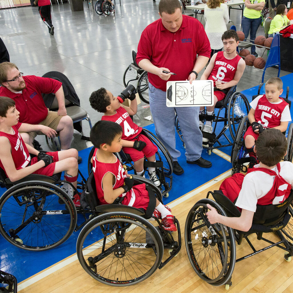Group of Children Sitting on Wheelchair Wearing Basketball Uniforms