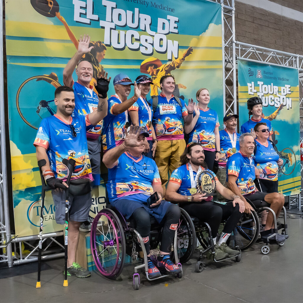 A group of people of various ability levels celebrate at the El Tour Tuscon