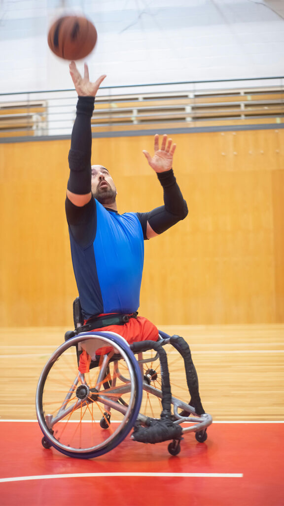 Man on a Wheelchair Playing Basketball