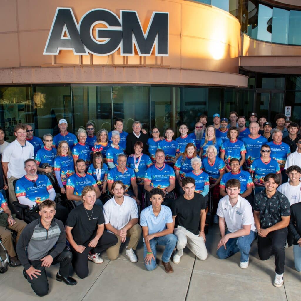 Team Access athletes, volunteers, and supporters gather for a group photo outside AGM Container Controls.