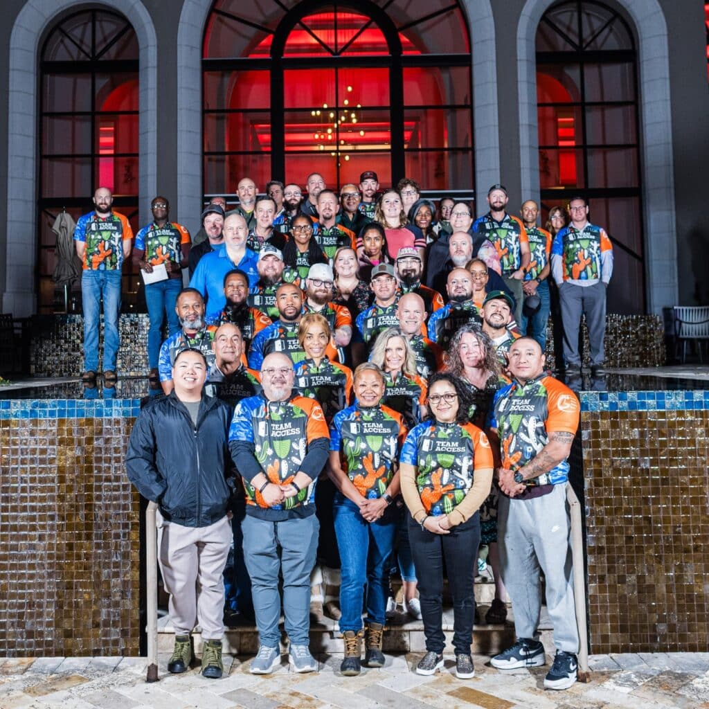 Team Access members, volunteers, and Wounded Warrior Project participants gather for a group photo at an appreciation dinner.